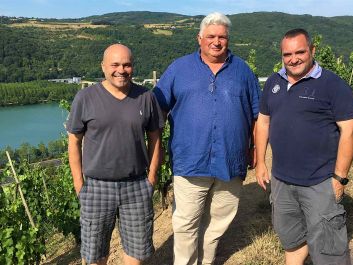 From left: Les Vins de Vienne partners François Villard, Pierre Gaillard and Yves Cuilleron on a steep vineyard slope in Seyssuel, overlooking the Rhône River.                                                                (Robert Camuto)
