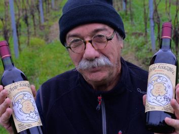 Bordeaux winemaker Gerard Descrambe holds up a Château Renaissance wine bottle with a label designed by the Charlie Hebdo cartoonist known as Tignous, killed in the terror attack.                                                                (Photo by Stephane Klein)
